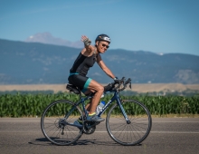 A woman rides a bike outside 